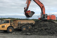 The excavator attachment crushes mined clay down to 4-in. minus while simultaneously loading haul trucks. Photo courtesy of Allu