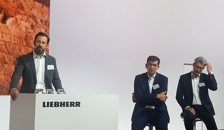 Liebherr hosted a MINExpo press conference Tuesday to discuss concepts such as autonomous operations, remote service support and decarbonization. Pictured here from left are Stephen Albrecht, Jörg Lukowski and Oliver Weiss. Photo: P&Q Staff