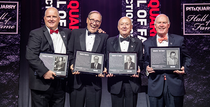 From left: Chris Nawalaniec, Dave Thomey, EJ Burke and John Baker II share a moment on stage following the conclusion of the 2022 Pit & Quarry Hall of Fame Induction Ceremony. Photo: PamElla Lee Photography
